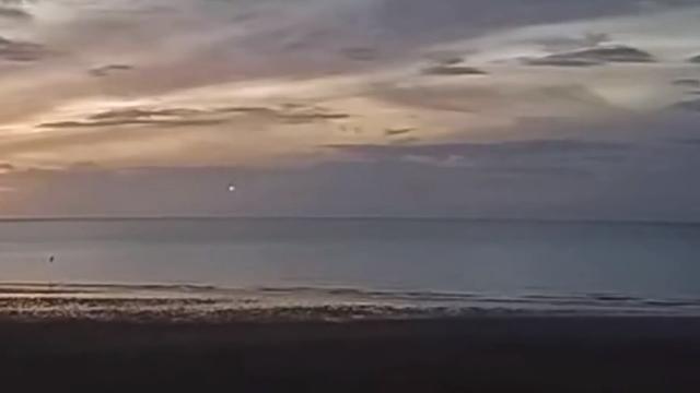 A glowing light was spotted hovering at the left side of the frame before it darted across to the right